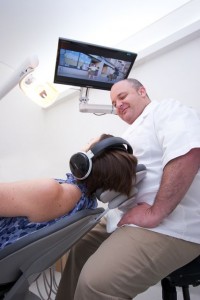 Dr David Kerr conducting dental treatment procedure on a female patient