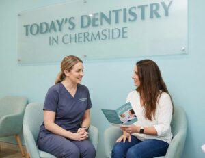 A dental professional at Today's Dentistry in Chermside consulting with a patient about sedation options to manage dental anxiety in a calming office setting.