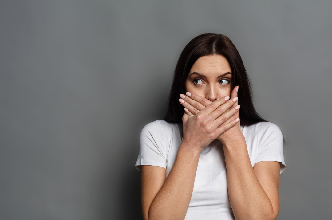 Woman covering mouth
